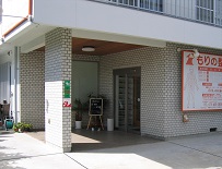 もりの整骨院の外観です。人の絵が描かれた大きな看板が目印です。自転車・バイクは地面がタイルの所に置いてください。